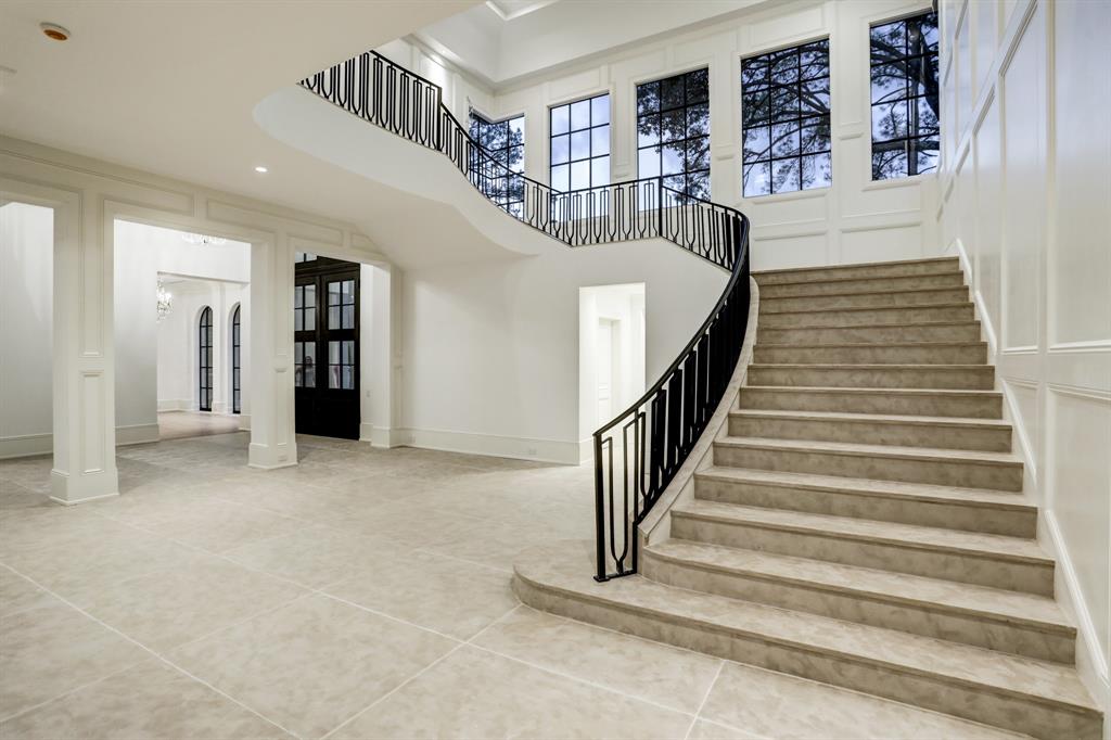 The grand the stair hall where the ceiling soars up to 30' at the center of a domed cove feature. (Photo by TK Images)