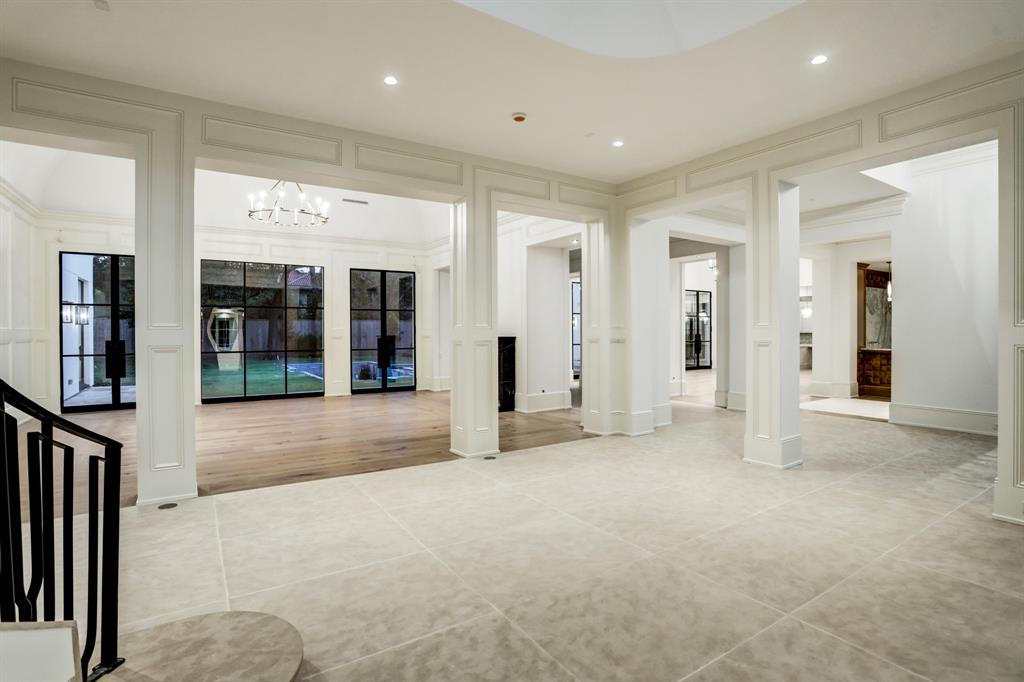  The stair hall at 3001 Inwood with block paneled columns that separate the room from adjacent areas and with oversized Savonnieres limestone tile floors. (Photo by TK Images)