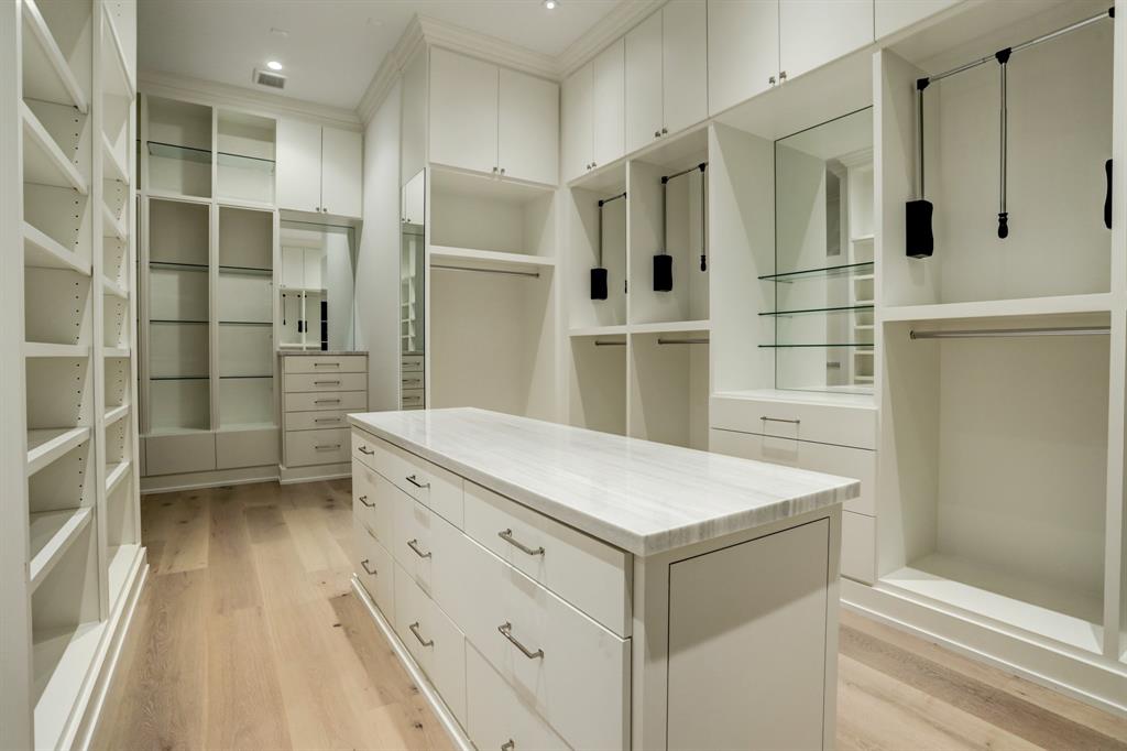 Floor-to-ceiling custom storage in the lady's closet in the primary bedroom. (Photo by TK Images)