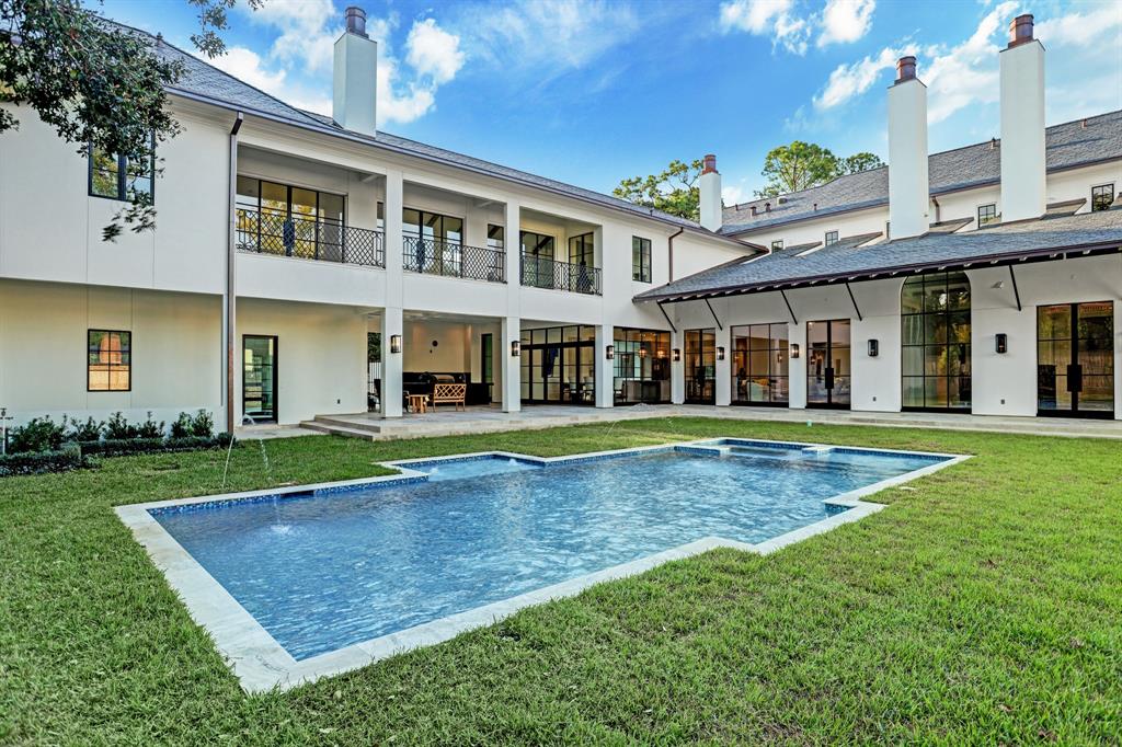 The in-ground swimming pool and spa provide a dramatic viewpoint to the back of the 12,095 square foot River Oaks mansion. (Photo by TK Images)