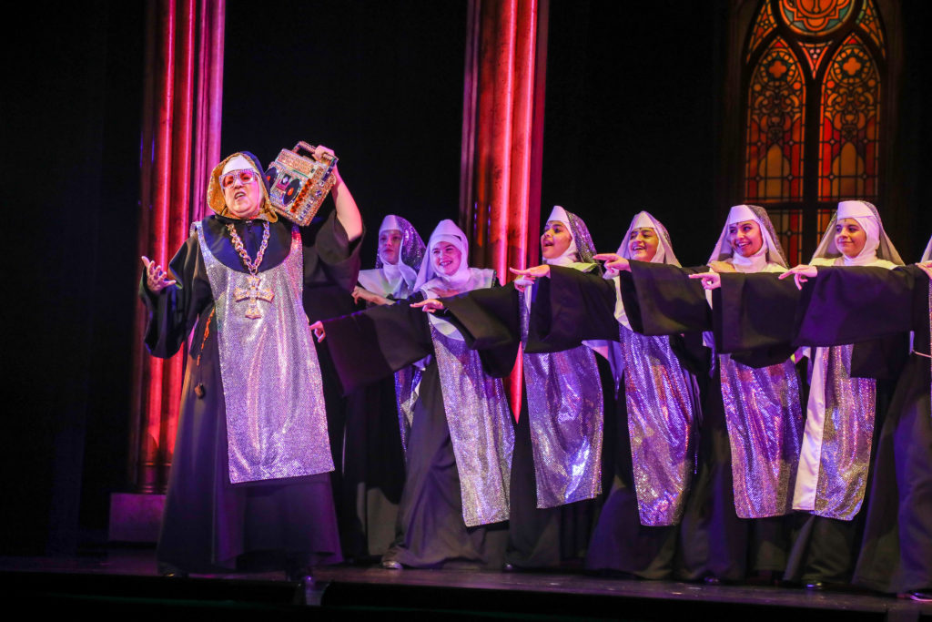Cathy Newman as “Mary Lazarus” and the cast of the TUTS production of Sister Act.