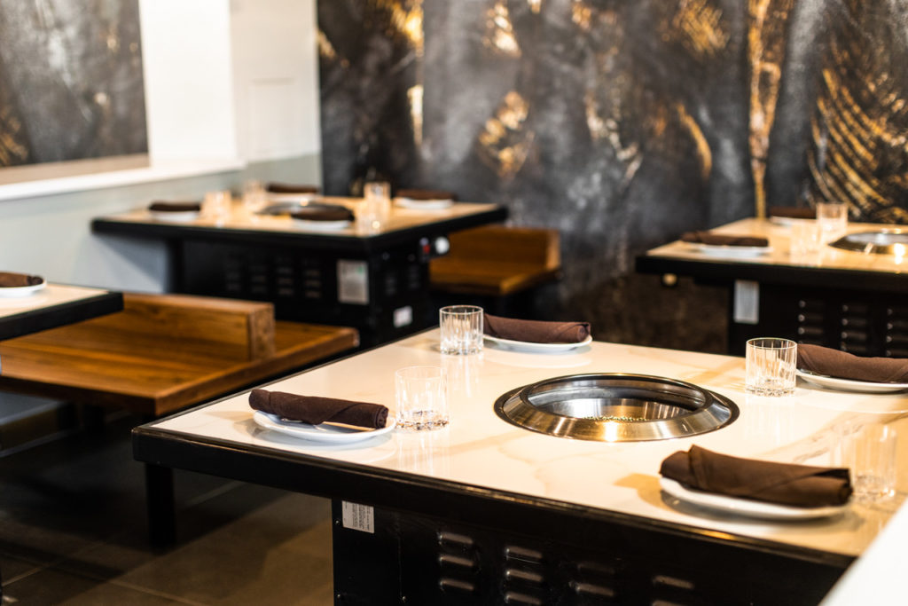 Tables at Nuri Grill each have their own grill so servers can cook meats for guests at their table. (Photo by Kathy Tran)