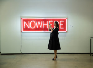 A visitor in front of a neon artwork by Alicia Eggert. Dallas Art Fair Preview, 2021. Credit Exploredinary (Photo by Exploredinary)
