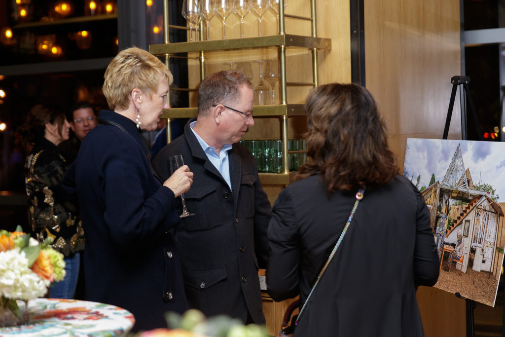 Guests looking at a photo of SWOON's work (Photography by William Neal).   (Photo by William Neal)