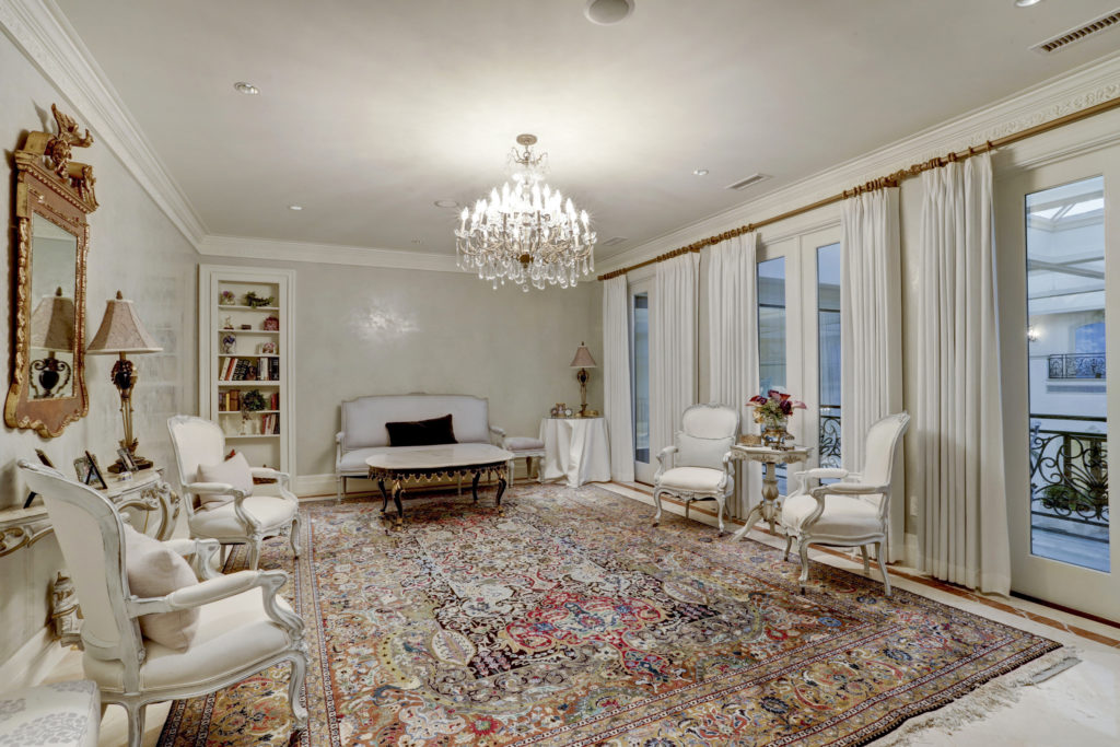The sitting area for the primary bedroom  has a balcony overlooking the indoor pool area. (Photo by TK Images)