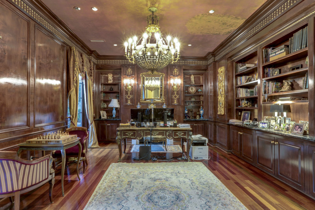 The study at 2115 River Oaks Boulevard is ensconced in classic mahogany paneled walls, timeless wood flooring, custom shelving and lavish gold trimmed details. (Photo by TK Images)