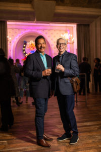S-Class – invitees with the glow of the neon bar in the background