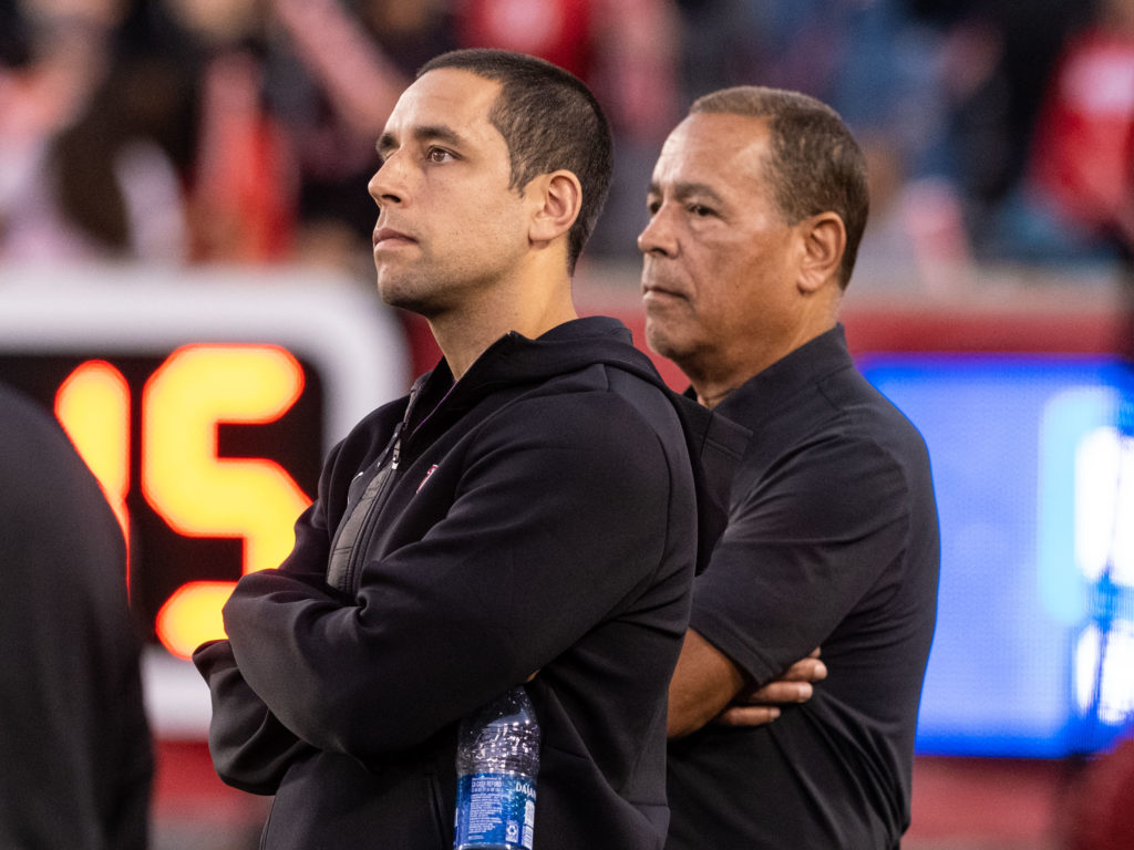 Kellen and Kelvin Sampson are UH football supporters. Here, they watch the SMU game from the sideline. (Photo by F. Carter Smith)