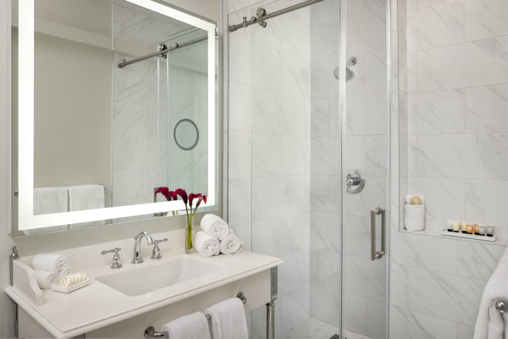 Bathrooms in guest rooms at the Warwick now include glass-enclosed showers and marble flooring with new vanities, toilets, and mirrors.