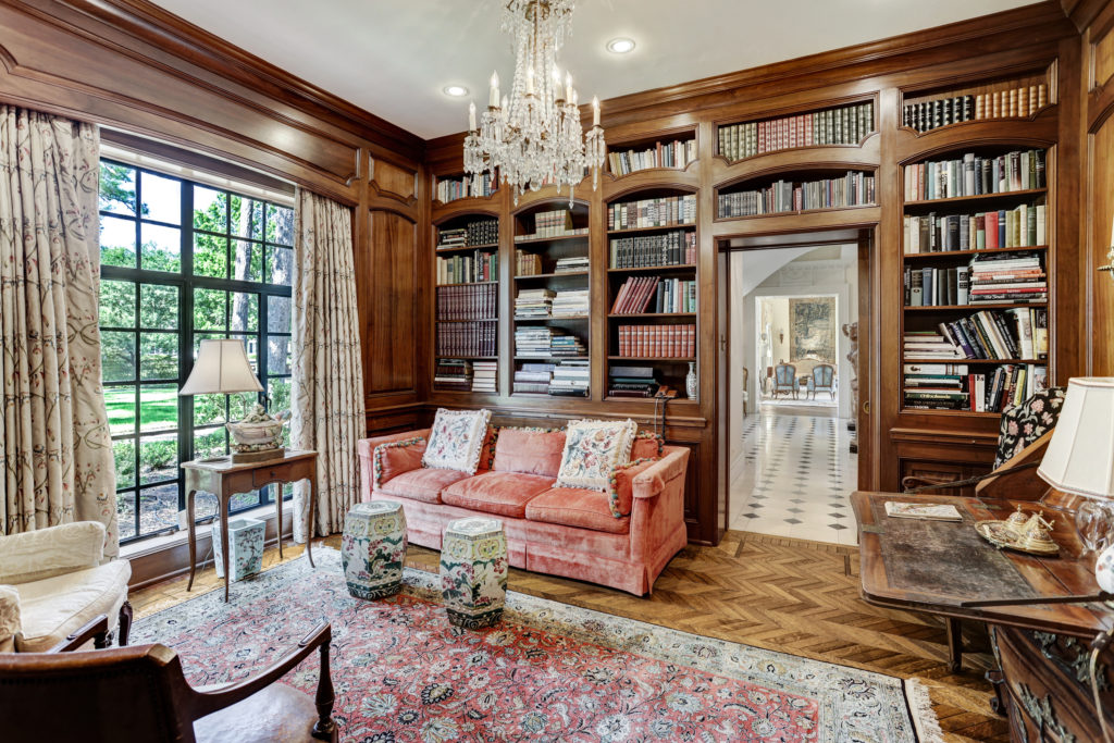The fully paneled library at 3781 Willowick overlooks the verdant terrain of the 1.63 acre lot. (Photo by TK Images)