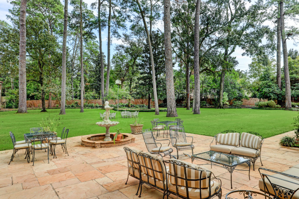 The patio deck overlooks the tree-shaded lawn. (Photo by TK Images)
