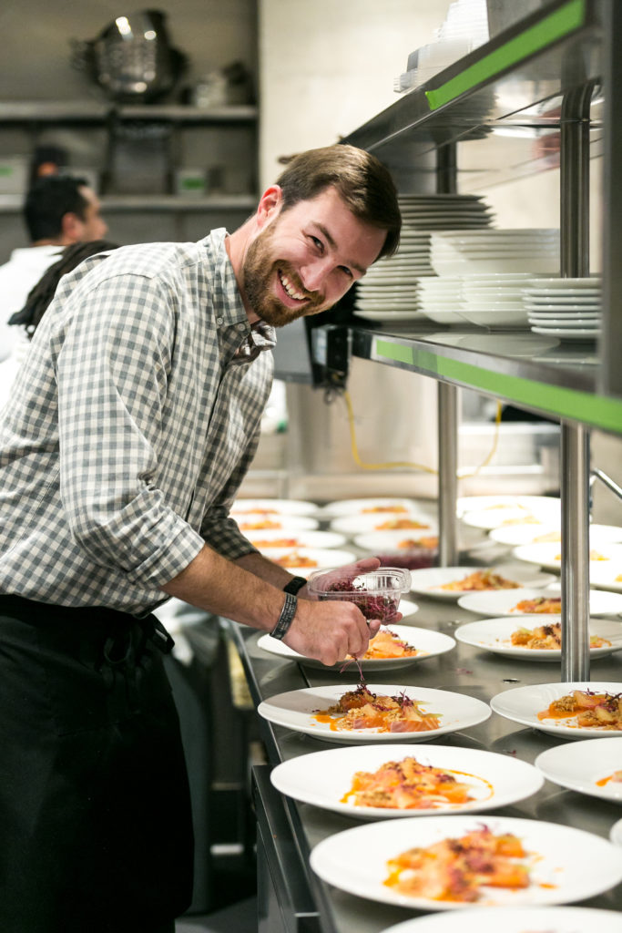 Tony's chef Austin Waiter prepares the first course, salmon crudo, for the Urban Harvest Sunday Supper. (Photo by Emily Jaschke)