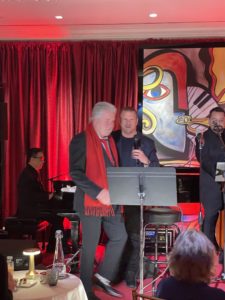 Hospitality magnate Tilman Fertitta introduces songman Steve Tyrell at the Café Post Oak, replicating the famed Café Carlyle where Tyrell performed before COVID forced its closure.