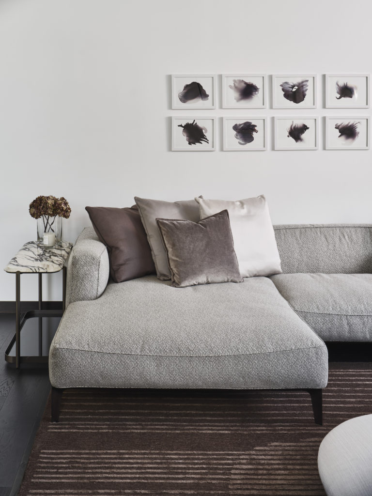 Giorgetti sofa, sidetable and area rug paired with John David Robbins "Smokes 1-12" series artwork.