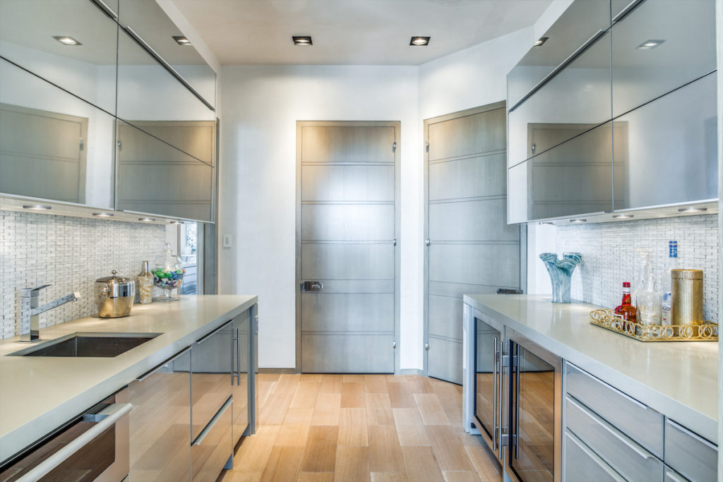 A tucked-away wet bar and plenty of storage. (Photo by Shoot2Sell for Douglas Elliman)