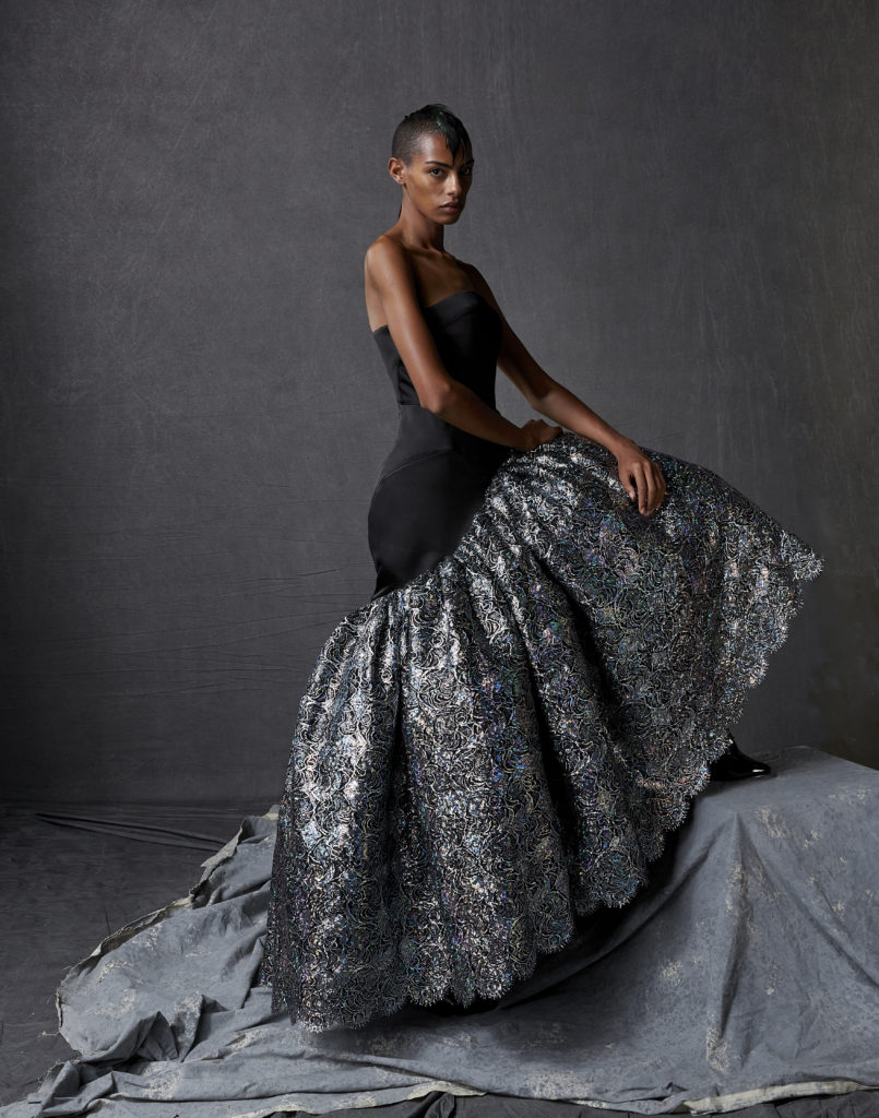 Bach Mai black silk satin cuir strapless column gown with silver crystal holofoil corded lace sculptured volant.(Photo by Dimitri Hyacinthe)