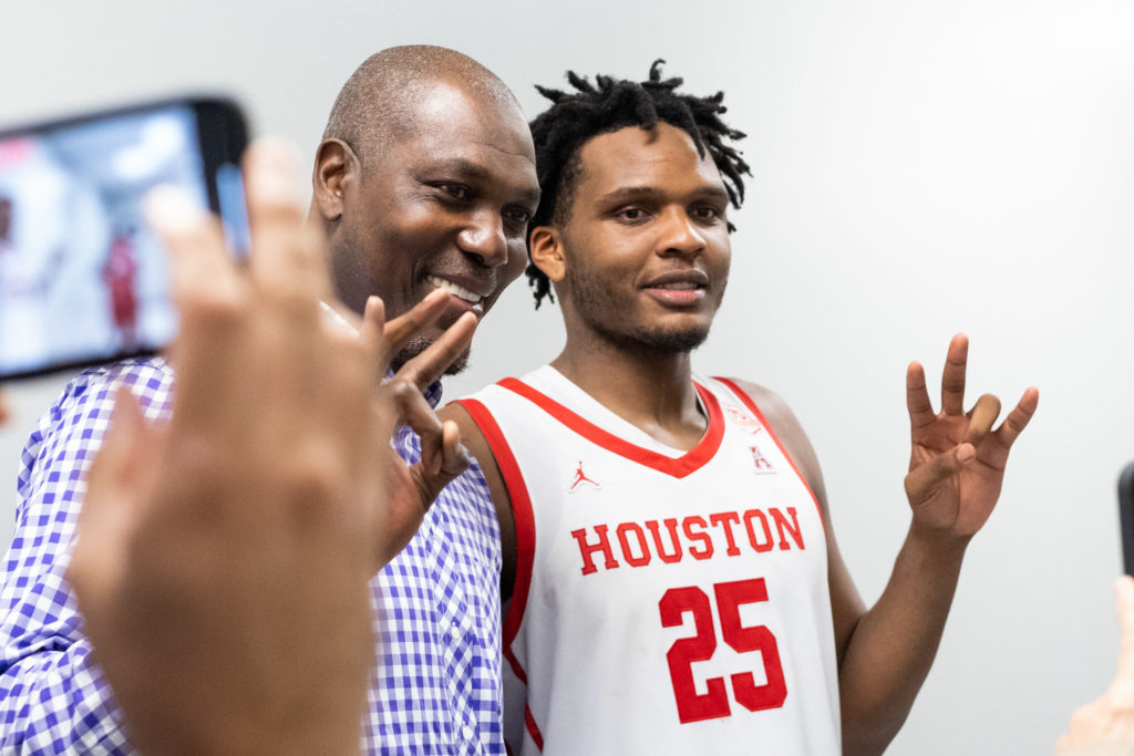 Being with Hakeem Olajuwon means plenty of attention. UH center Josh Carlton earned it. (Photo by F. Carter Smith)