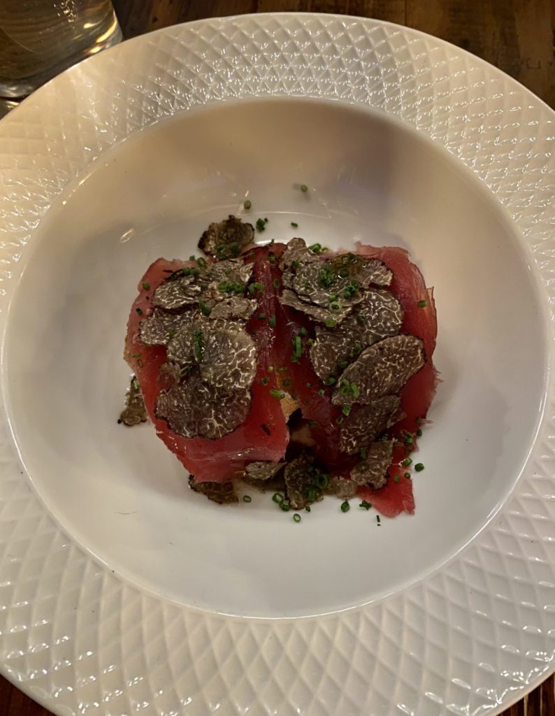 The Bluefin sashimi atop a crispy chicken thigh and garnished with truffles is one of the best things to try at Cry Wolf. (Photo by Megan Ziots)