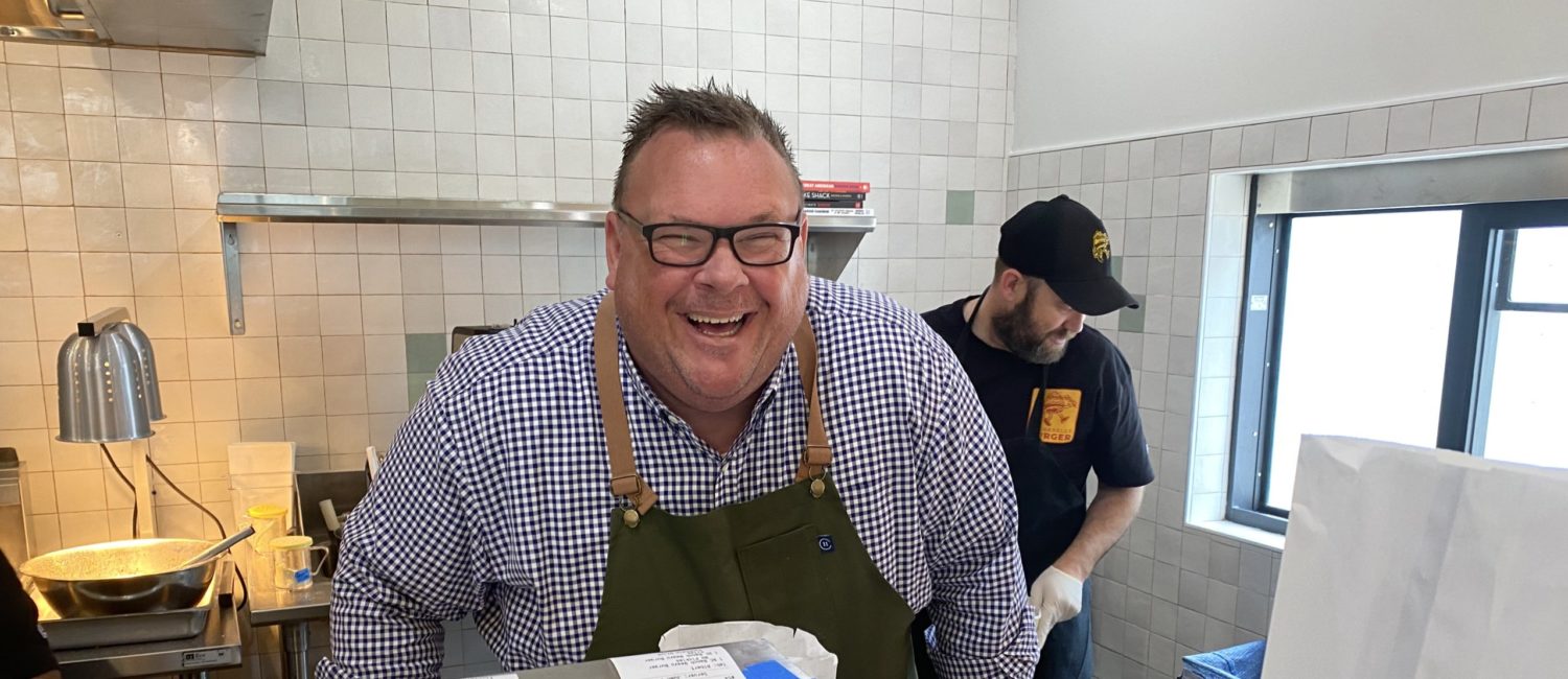 Chef Chris Shepherd shares a smile on the second day of service at his Underbelly Burger joint at Houston Farmers Market where the fans are already pouring in. (Photo by Shelby Hodge)