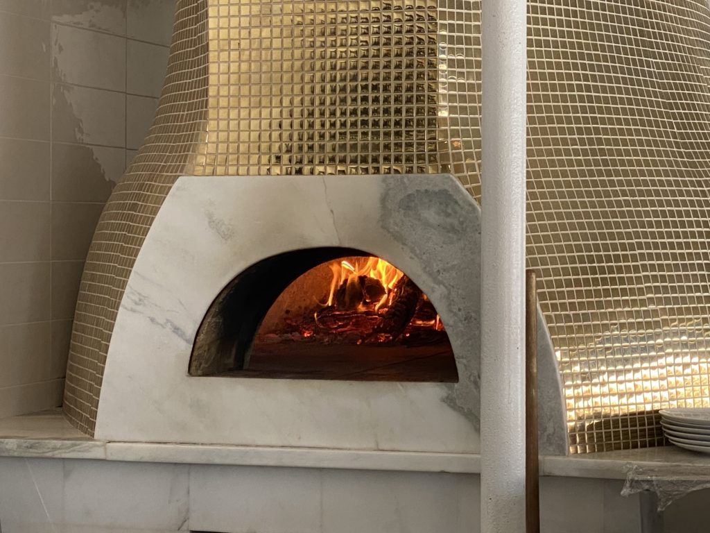 The gold tiled pizza oven at Amore Italian Restaurant, under the toque of chef Alfredo Mojica. (Photo by Shelby Hodge)