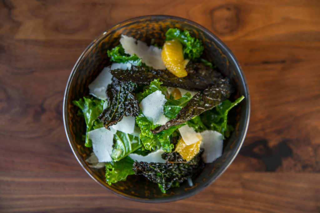 The kale salad ($14) at Back Table is a combination of curly kale and crisp kale leaves in a citrus dressing with parmesan shavings. (Photo by Photos Care of Back Table Kitchen & Bar)