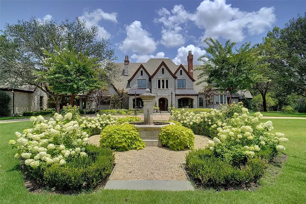 Grand estate with fountain and romantic Tudor style chimney stacks.