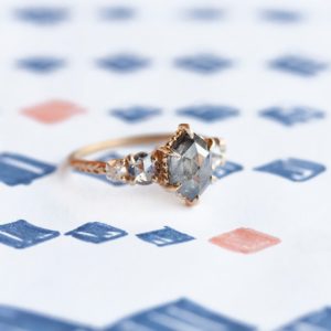 diamond – evergreen five stone setting with slick gray sheen