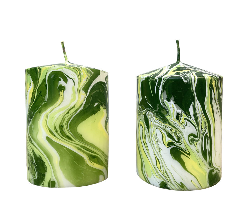 Green pillar candles at the Casa Branca pop-up at The Conservatory on Two, which runs through March 18