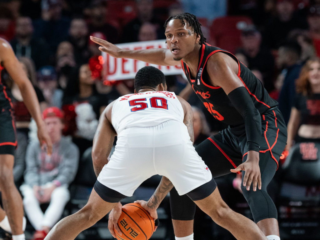 SMU forward Marcus Weathers found UH center Josh Carlton blocking his way. (Photo by F. Carter Smith)