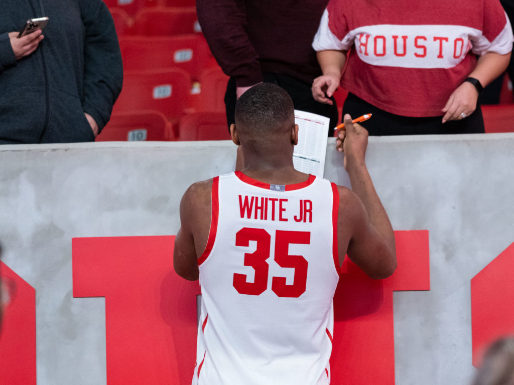 Fabian White Jr. signs an autograph for a UH fan. (Photo by F. Carter Smith)
