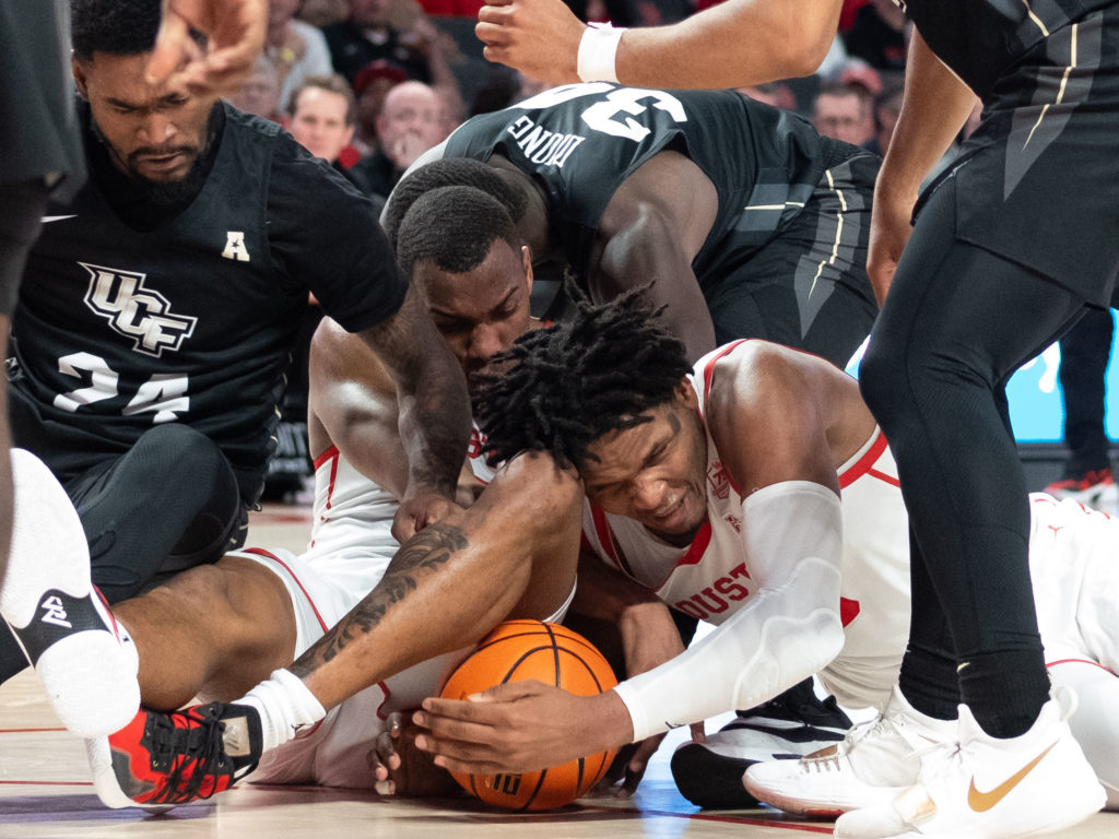 Fabian White Jr. and Josh Carlton know you need to fight for the ball to have the chance to win consistently. It's the UH way. (Photo by F. Carter Smith)