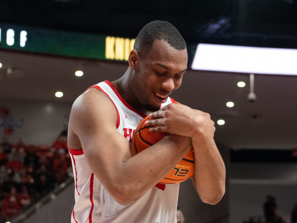 Fabian White Jr. cradled the basketball after winning his 110th game, more than any other player in the long, impressive history of the University of Houston basketball program. (Photo by F. Carter Smith)