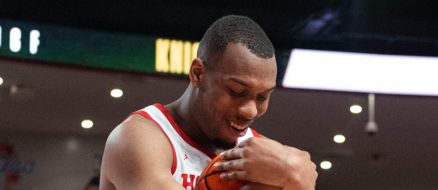 Fabian White Jr. cradled the basketball after winning his 110th game, more than any other player in the long, impressive history of the University of Houston basketball program. (Photo by F. Carter Smith)