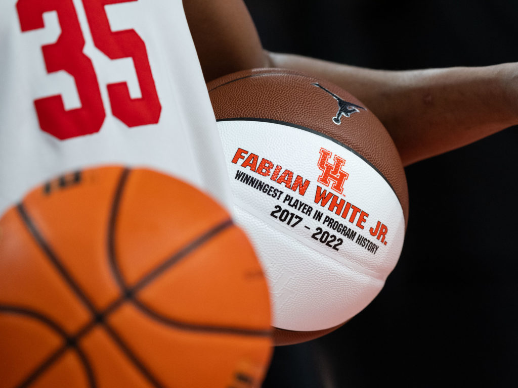 Fabian White Jr. walked away with the game ball and commemorative basketball after becoming the winningest UH player of all time. (Photo by F. Carter Smith)