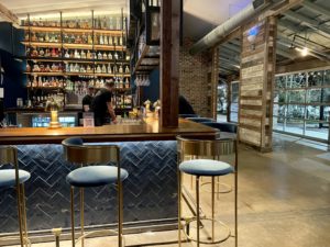 Courtside – Bar area opens onto lush patio and pickleball courts. Photo by Courtney Dabney.