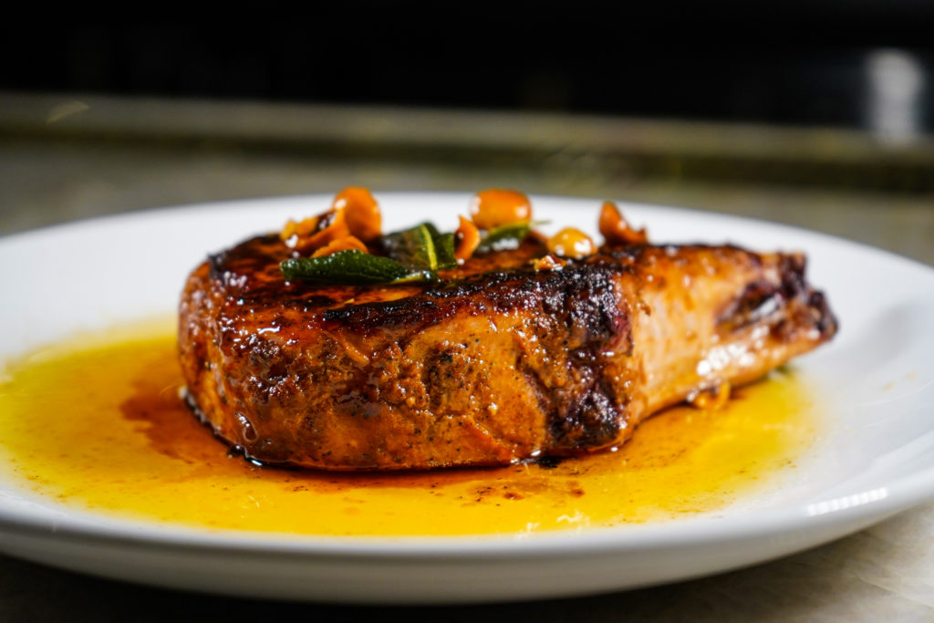 Juliet's double pork chop is one of a number of proteins on the menu at the new Galleria area restaurant. (Photo by In-House Social)