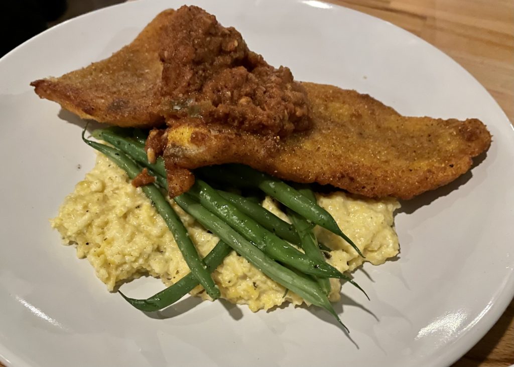  Delta fried catfish is dreamy atop poblano grits. Photo by Courtney Dabney.