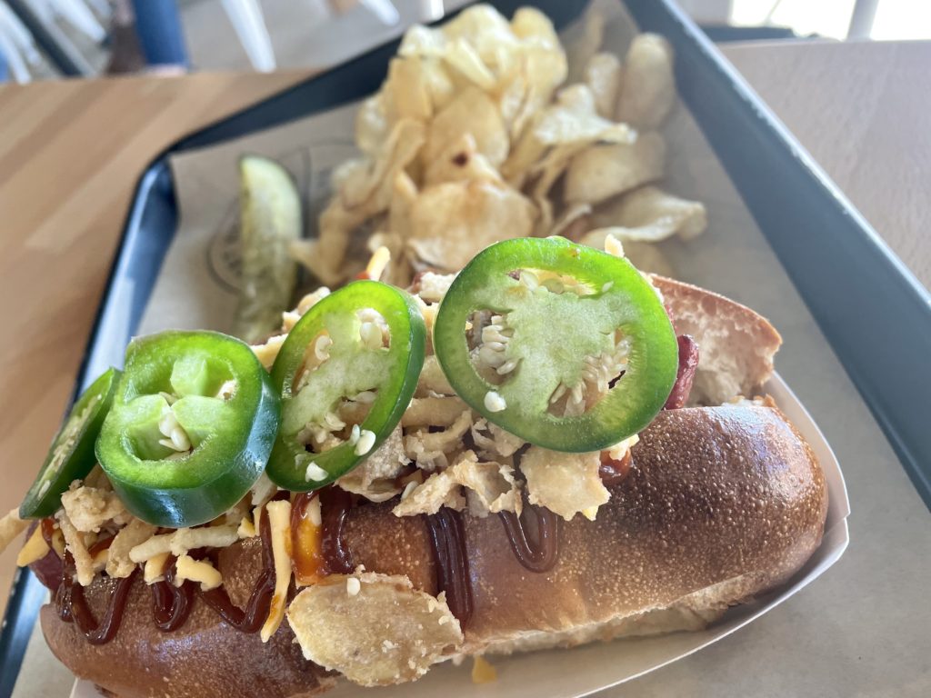 The Big Tex Dog topped with fried onions, BBQ sauce and jalapeno slices. Photo by Courtney Dabney.