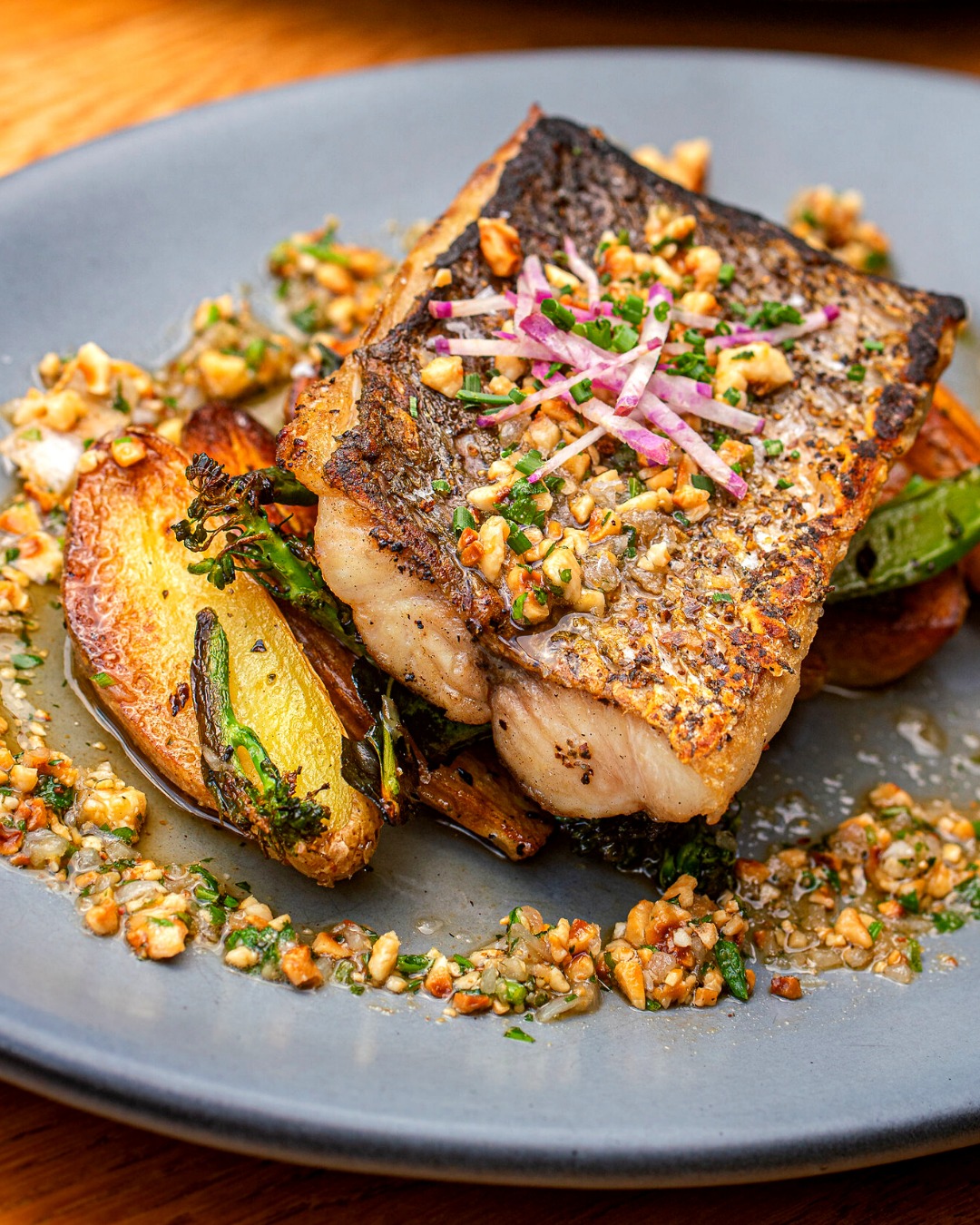 Plank – Wood grilled redfish with hazelnut brown butter, lemon, fingerling potato and broccolini.