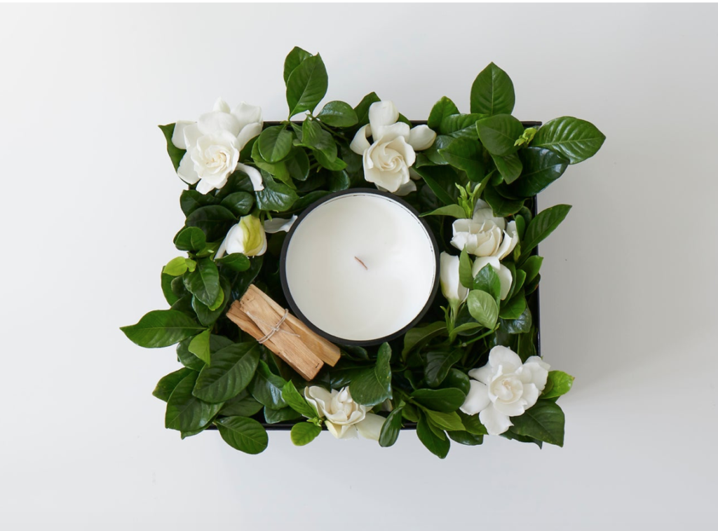 Fresh gardenia blossoms and a divine candle from High Camp Ephemeral Luxury.