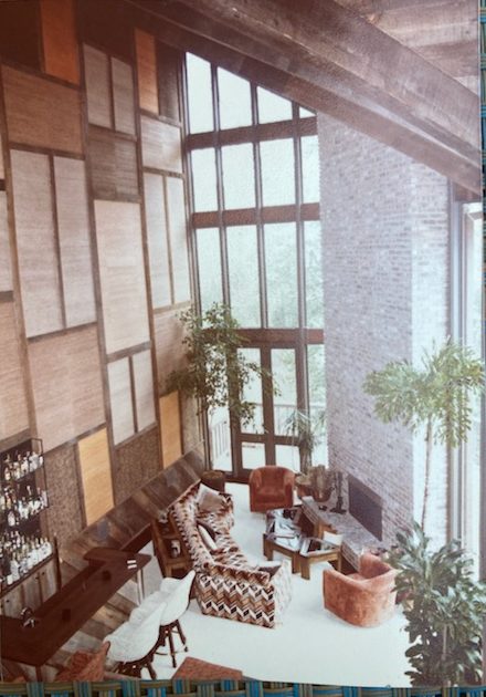 Soaring 31-foot tall ceilings, brick, natural grasscloth, cork and wood were part of the living room interior design.