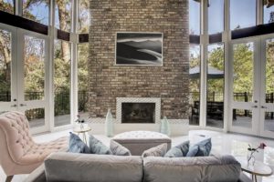 The floor-to-ceiling fireplace is a signature element of the living room in this Houston Tree House.