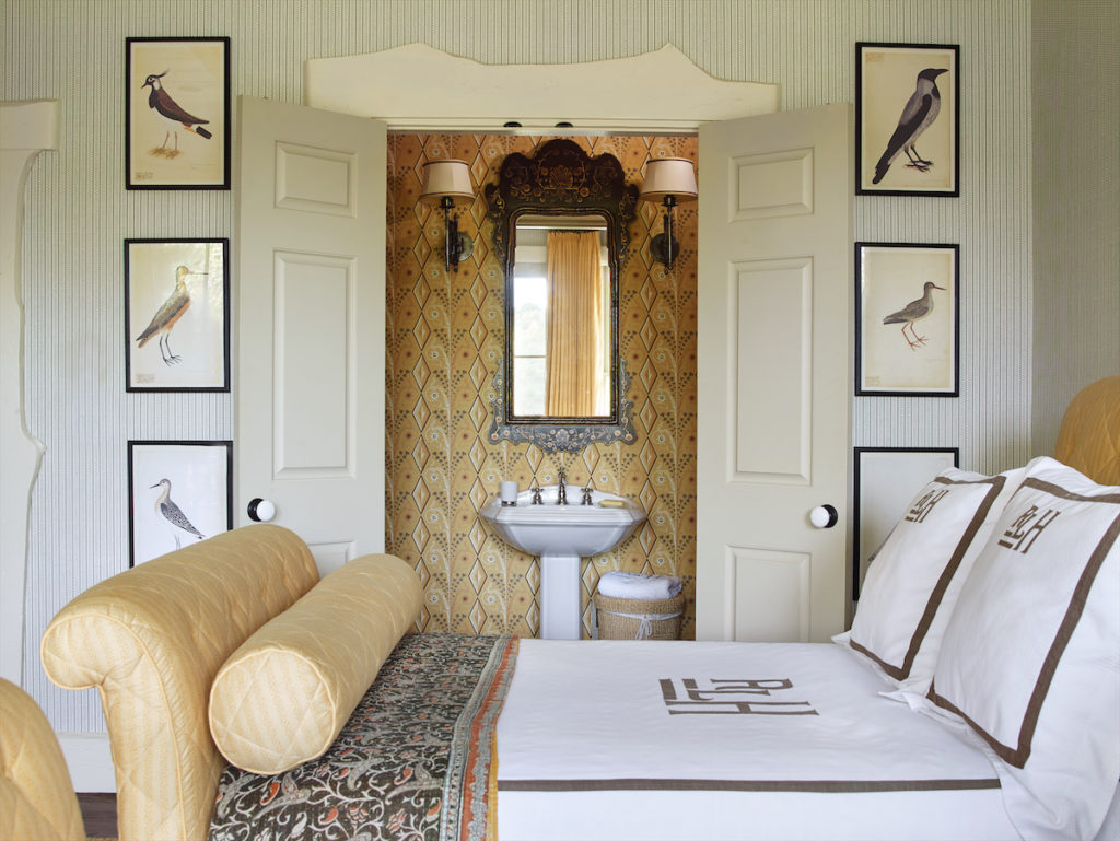 A bedroom in the main house with a bird theme, including a collection of avian prints. Monogrammed Leontine Linens. (Photo by Tria Giovan)