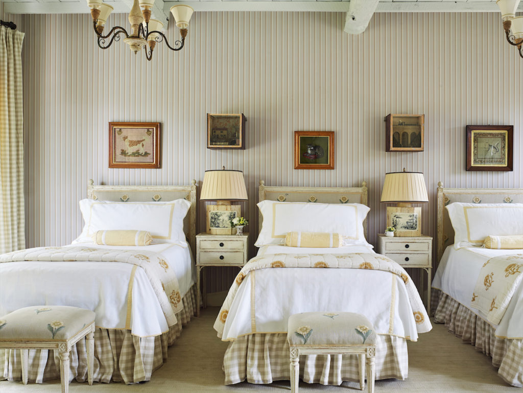 Chelsea Textiles headboards upholstered in sunflower embroidered fabric. Les Indiennes quilts are also printed with sunflowers. (Photo by Tria Giovan)