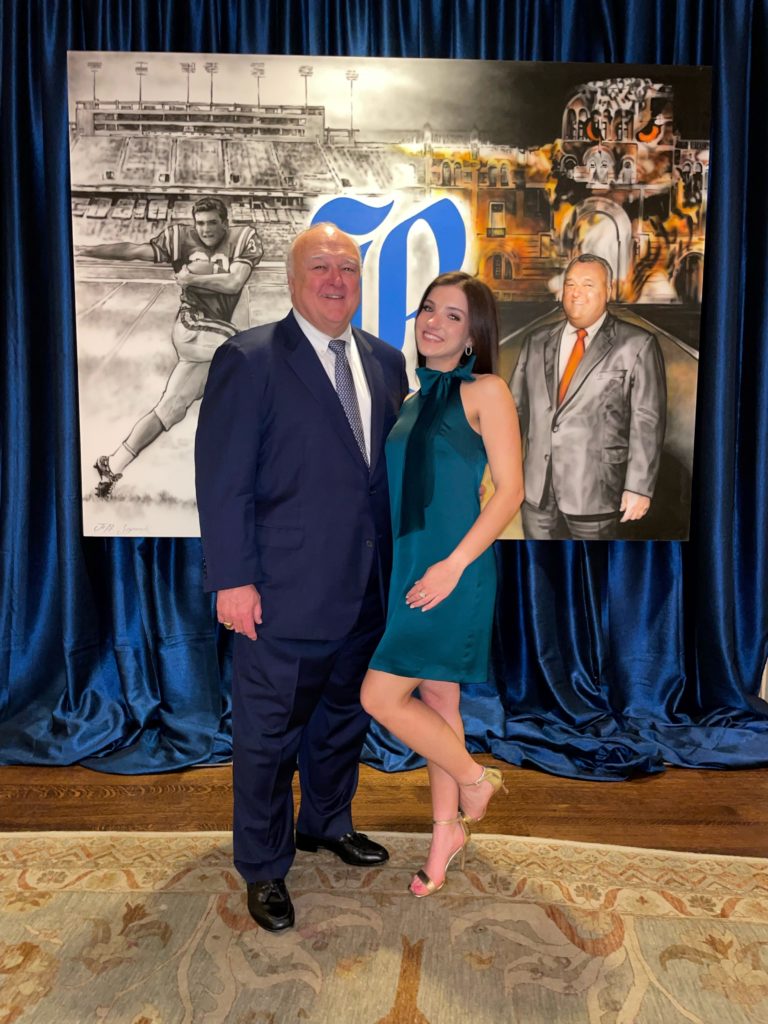Honoree Bucky Allshouse, daughter Channing Allshouse in front of the mural created by The Events Company with Richard Flowers