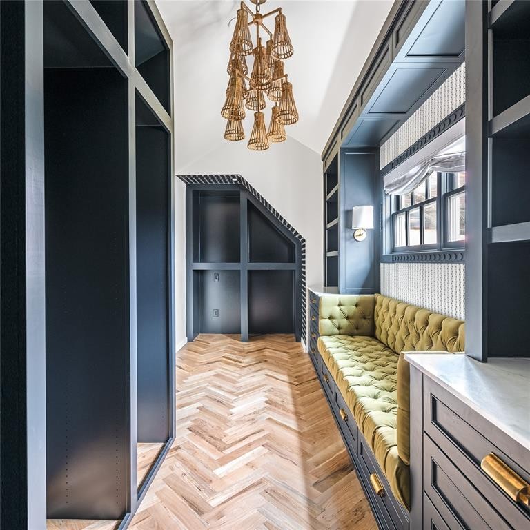 Much of the work from Dallas-based Burkle Creative remains in the primary closet, including bespoke built-ins, the rattan chandelier, and detailed trim work by Casci Plaster. (Photo by Costa Christ Media)