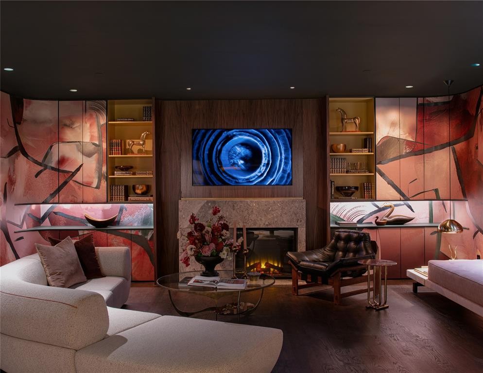 While many of the most colorful rooms were wiped clean post-Kips Bay, Ever Atelier’s hand-painted suede walls still wrap the immersive basement. A Strike fireplace by Chad Dorsey and a curved B&B Italia sofa also stayed behind. (Photo by Costa Christ Media)