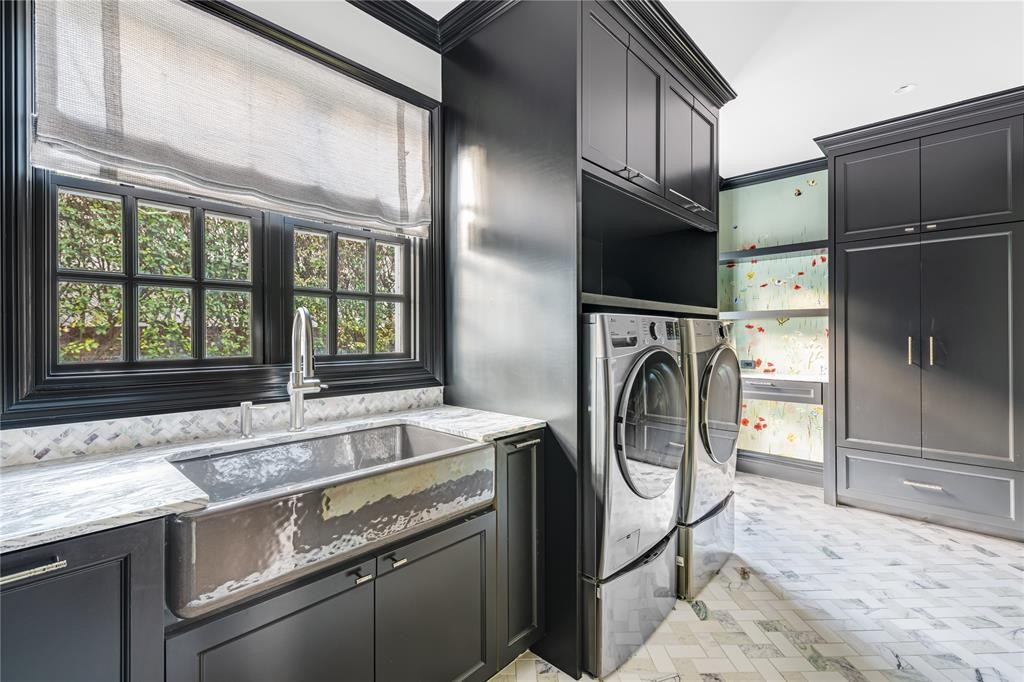 Hand-painted wallpaper by Fromental still serves as the backdrop for the ultra-chic laundry room. (Photo by Costa Christ Media)
