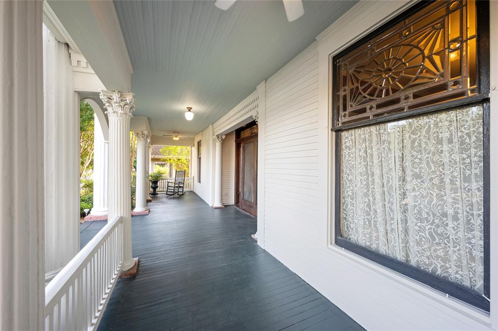 A charming front porch, a defining element of Greek Revival architecture. 