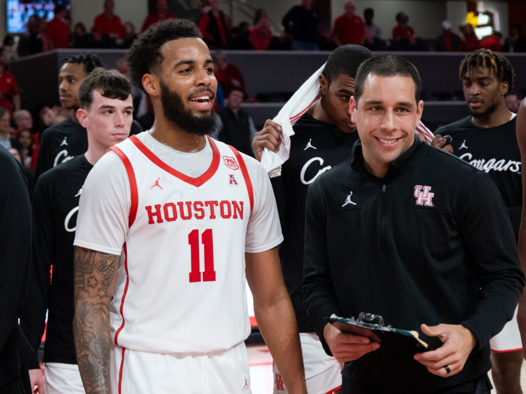 University of Houston guard Kyler Edwards and assistant coach Kellen Sampson share a moment after another big win. (Photo by F. Carter Smith)